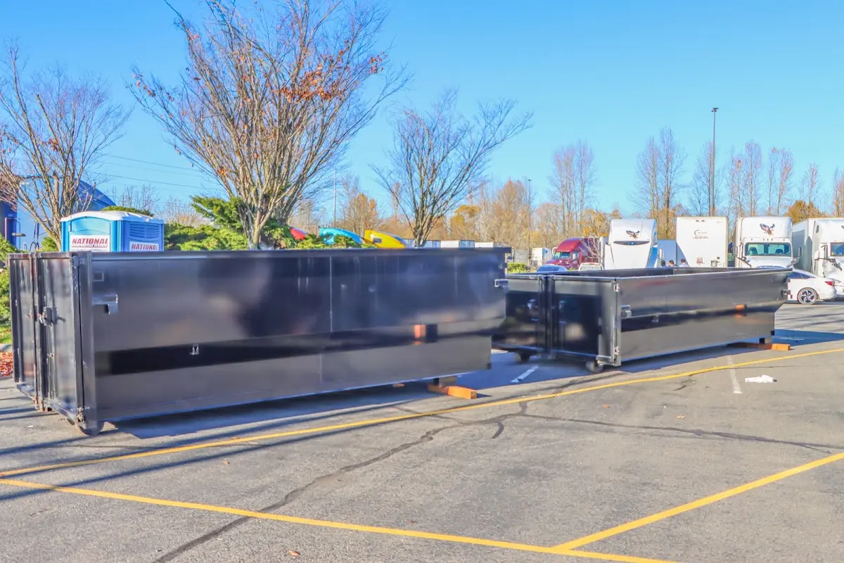Professional dumpster rental service with roll-off container on residential driveway in McLendon-Chisholm